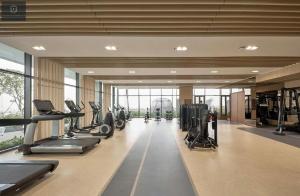 a gym with treadmills and cardio equipment in a building at The Metropole Deluxe Apartment View City in Ho Chi Minh City