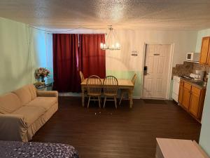 a living room with a couch and a table with chairs at THE FLORIDIAN INN in Clearwater
