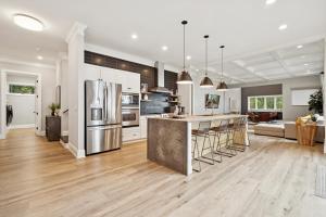 a kitchen with white cabinets and stainless steel appliances at Paradise Peninsula in Lake Norman of Catawba