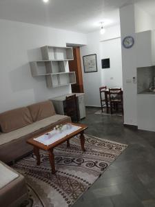 a living room with a couch and a coffee table at Aila Apartament in Gjirokastër