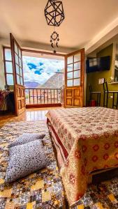a bedroom with a bed with a view of the mountains at Aqui y Ahora in Pisac +18 photos