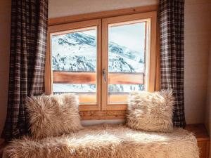 a window with a view of a snow covered mountain at Superbe chalet 5 chambres avec cheminée et accès privatif à Avoriaz - FR-1-314-161 in Morzine +10 photos
