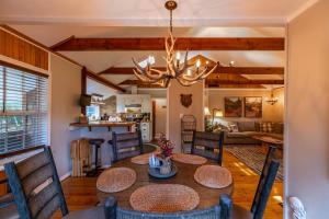 a dining room and living room with a table and chairs at Four Bear Falls in Banner Elk