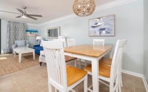 a dining room with a table and chairs at Phoenix East 203 condo in Orange Beach
