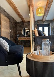 a living room with a couch and a table at Keriana Luxe et détente privée en Alsace in Muttersholtz +25 photos
