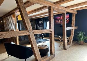 a room with a wooden structure with a table and a chair at Keriana Luxe et détente privée en Alsace in Muttersholtz
