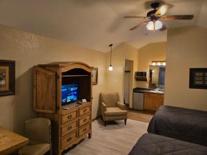 a room with a bedroom with a bed and a television at Texas Star Lodges in Floresville