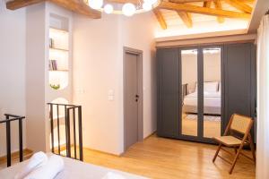 a bedroom with a door leading to a bed at Milies Memories Pelion in Mileai