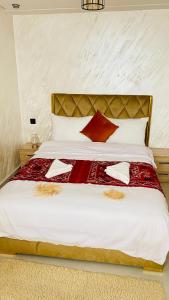 a bedroom with a large white bed with red pillows at Imsouane Sea surf in Imsouane