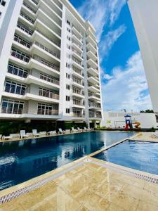a swimming pool in front of a building at Bubbles Cozy Homes Two bedroom apartment in Mombasa