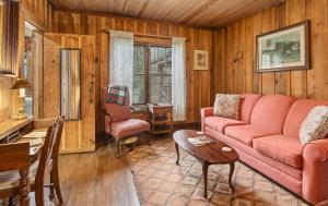 a living room with a red couch and a table at Glen Choga Lodge in Topton