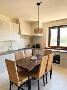 a kitchen with a wooden table and chairs at villa Diamante in Lamporecchio +36 photos