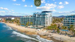 an aerial view of a beach with tall buildings at Luxury 2 BR Condo with Dream Pools - Beach - Art in Bucerías