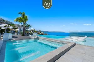 a swimming pool with a view of the ocean at Amazing 1 BR Condo in Romantic Zone - Pool - Gym in Puerto Vallarta