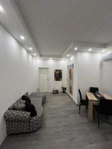 a living room with a couch and a table at Apartman UNO in Batajnica