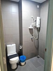 a small bathroom with a toilet and a shower at Couple Studio Cozy Room Klcc BY AA GLoBAL in Kuala Lumpur +13 photos