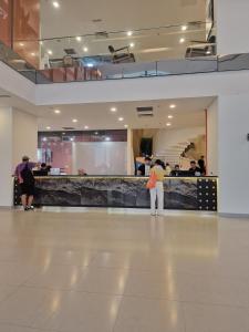 a group of people standing in a lobby at Couple Studio Cozy Room Klcc BY AA GLoBAL in Kuala Lumpur