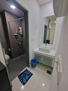 a bathroom with a sink and a toilet and a mirror at Couple Studio Cozy Room Klcc BY AA GLoBAL in Kuala Lumpur