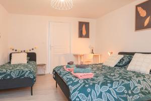 a bedroom with a bed with a teddy bear on it at Charme et confort au coeur de Mulhouse - Dolce Vita in Mulhouse