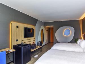 Ένα ή περισσότερα κρεβάτια σε δωμάτιο στο Pullman Lima San Isidro