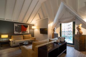 a living room with a couch and a table at Eurostars Indautxu in Bilbao