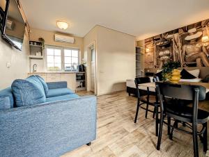 a living room with a blue couch and a table at Palanga INN in Palanga