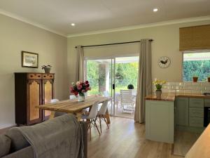 a kitchen and dining room with a table and chairs at Autumn Way in Clarens