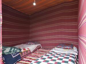 a small room with two beds in it at Merzouga Standard Camp in Merzouga