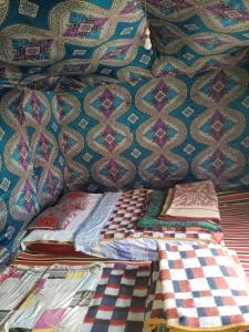 a group of beds sitting next to each other at Merzouga Standard Camp in Merzouga