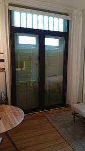 a large glass door with blinds in a living room at AmazINN Places Hotel Boutique Casa Marichu in Panama City
