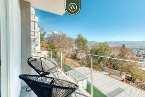 two chairs sitting on a balcony with a view at 3 BR Condo - Panoramic Views - 5 Min to Downtown in Oaxaca City