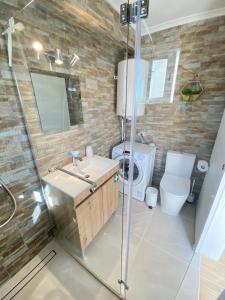 a bathroom with a shower and a sink and a toilet at Casa do Sol in Sagres +18 photos