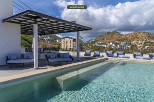 a swimming pool with chairs and a gazebo at Amazing Apt with City View - Rooftop Pool in Los Médanos Partidos
