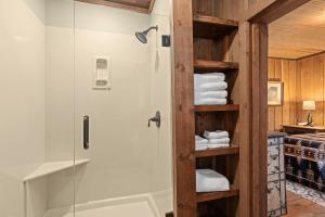 a bathroom with a shower and some towels at Glen Choga Lodge in Topton
