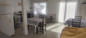 a kitchen with a table and chairs in a room at Lontana in Dique Luján