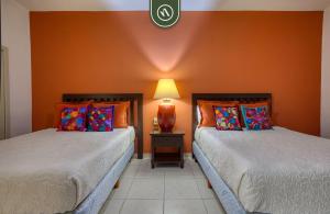 two beds sitting next to each other in a room at Mexican Styled 2 BR Condo - Beachfront - Pool in Nuevo Nayarit +29 photos