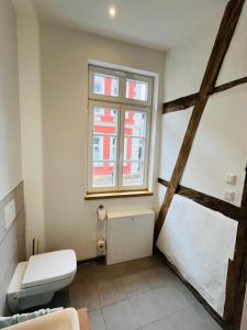a bathroom with a toilet and a window at Eibenhaus in Bad Iburg +58 photos