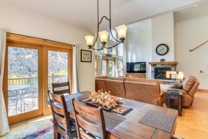 a dining room and living room with a table and chairs at Mtn-View Cabin with Private Hot Tub in Georgetown! in Georgetown