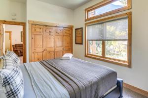 a bedroom with a bed and a window at Mtn-View Cabin with Private Hot Tub in Georgetown! in Georgetown
