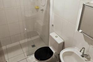 a bathroom with a shower and a toilet and a sink at Wooden House in Maria da Fé +15 photos