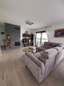 a living room with a couch and a fireplace at Kuća za odmor Husinec in Husinec