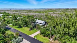 an aerial view of a house in the middle of trees at Your Island Oasis Awaits on Sanibel - Near Beach in James Cipriani Heliport