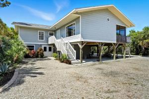 a house with a large driveway in front of it at Your Island Oasis Awaits on Sanibel - Near Beach in James Cipriani Heliport