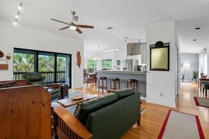 a living room with a couch and a table at Your Island Oasis Awaits on Sanibel - Near Beach in James Cipriani Heliport