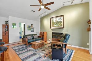 a living room with a couch and a fireplace at Your Island Oasis Awaits on Sanibel - Near Beach in James Cipriani Heliport +37 photos