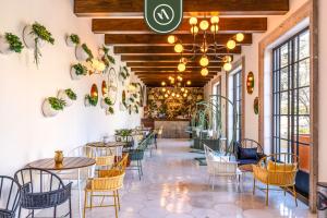 a restaurant with tables and chairs and a ceiling with a chandelier at 2BR House with Ocean View in Cabo in El Tule