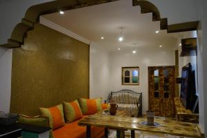 a living room with a couch and a table at Heaven Surf Camp in Agadir