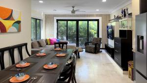 a living room with a table and a couch at Big & Luxury 2BR on 5th Ave, King Bed, 2 Baths in Playa del Carmen