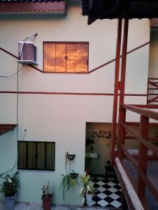 a building with a window and a checkered floor at Pousada flores in Porto Velho +1 photo