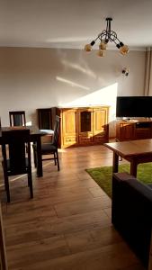 a living room with a table and a dining room at Apartament 7 Piętro in Bydgoszcz